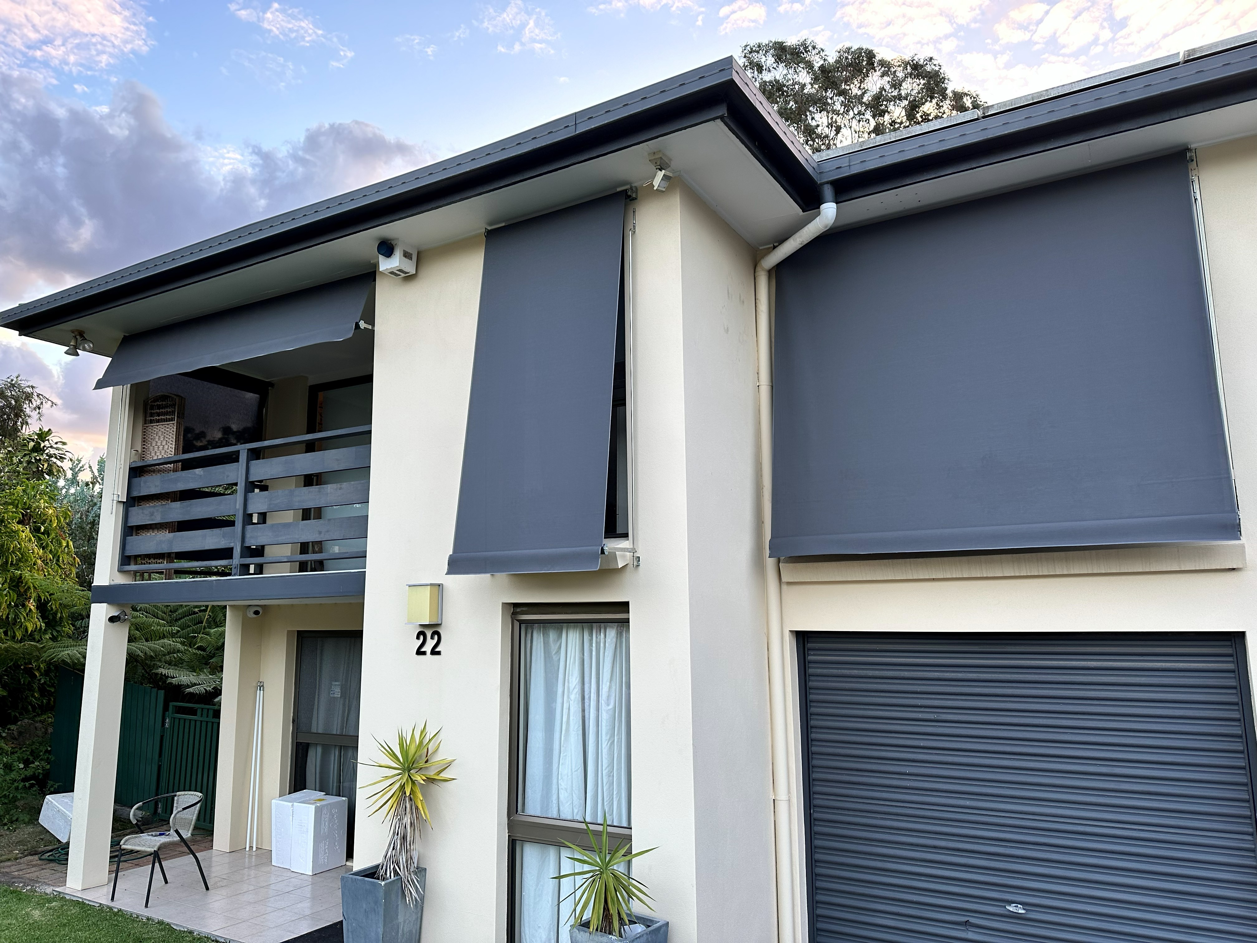 Two-storey home with auto guide awnings and roller doors fitted