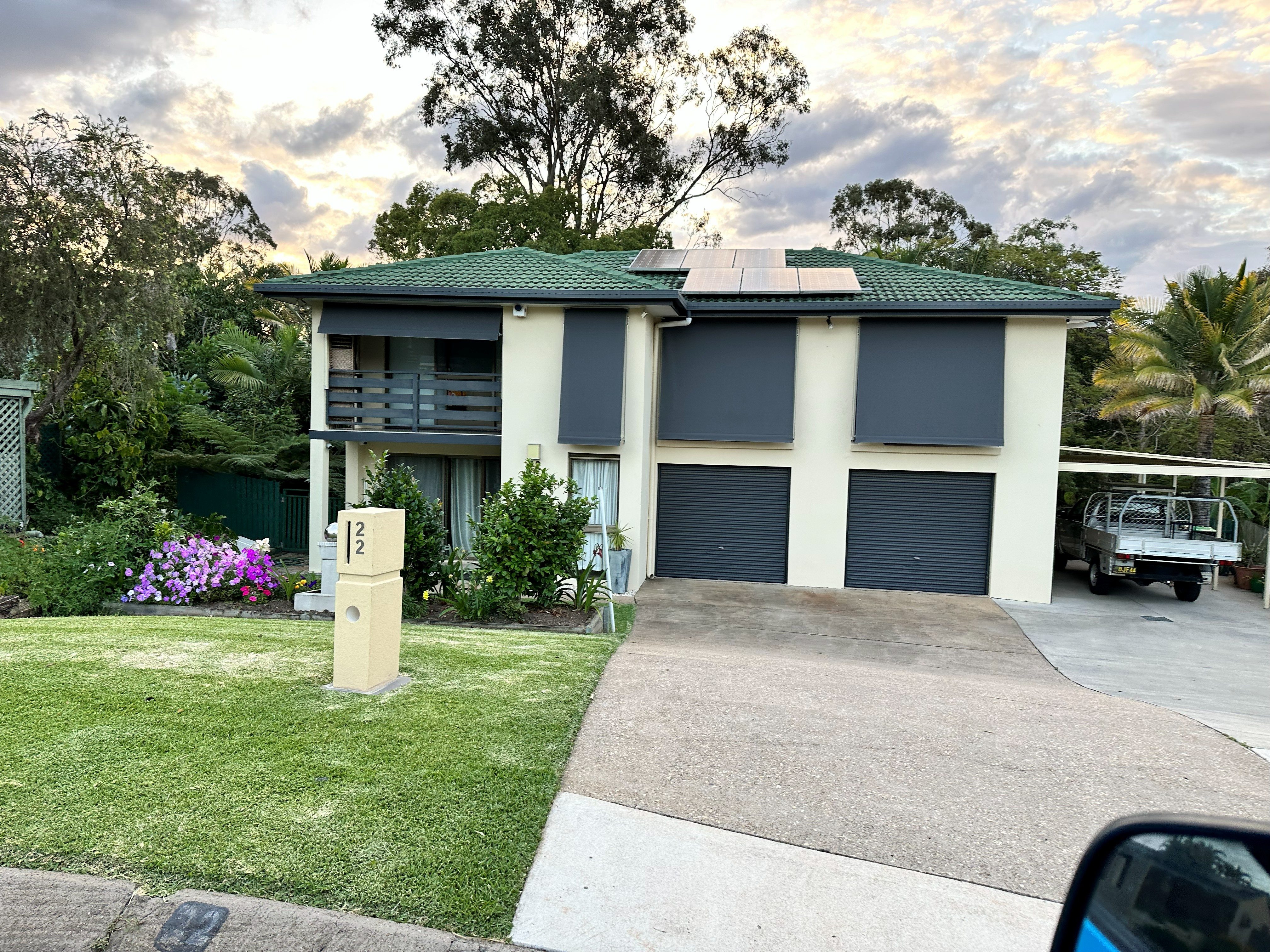 Beige auto guide awnings fitted to a brick home exterior