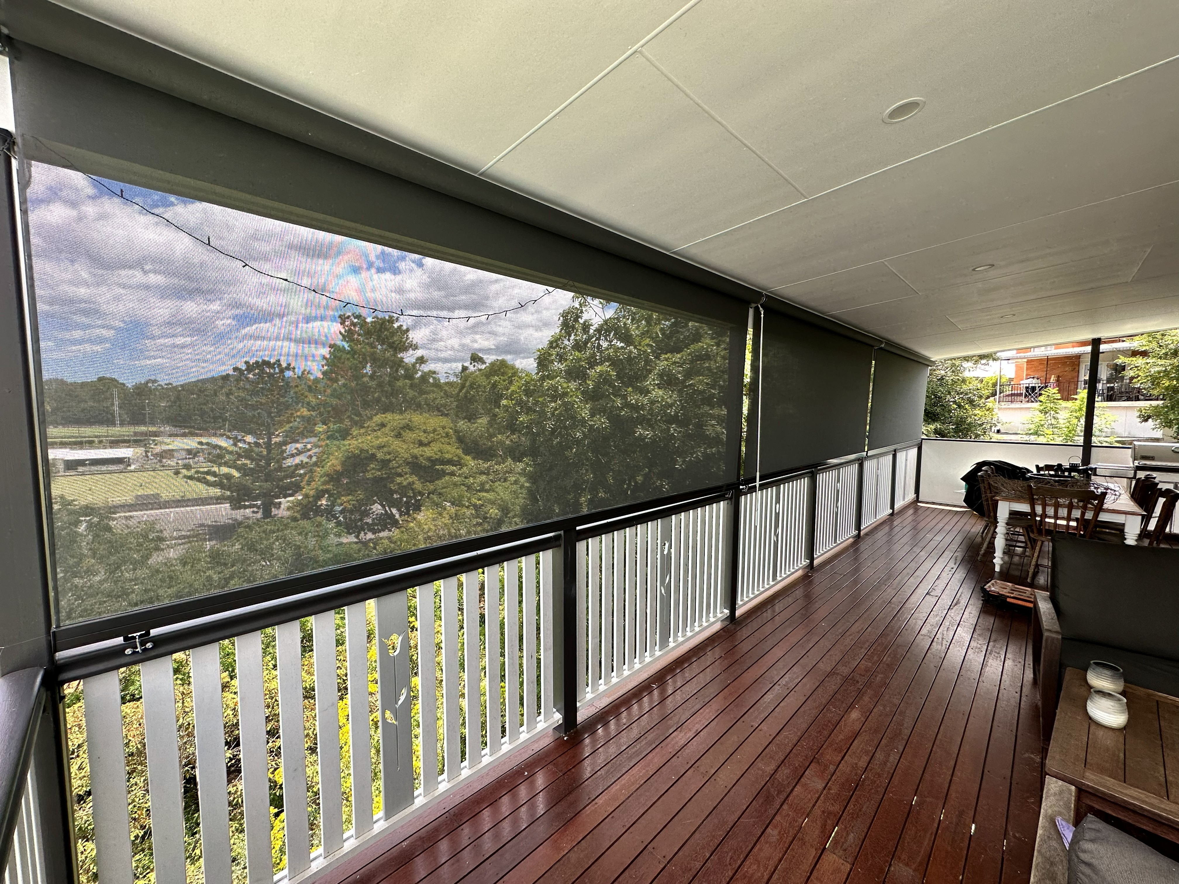 Crank operated outdoor blinds fitted along a covered deck entertaining area