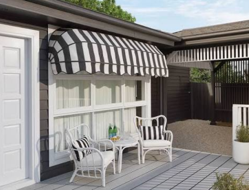Striped fixed canopy fabric awning over a covered deck seating area