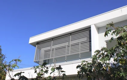 Grey louvre privacy screen fitted to a modern home balcony