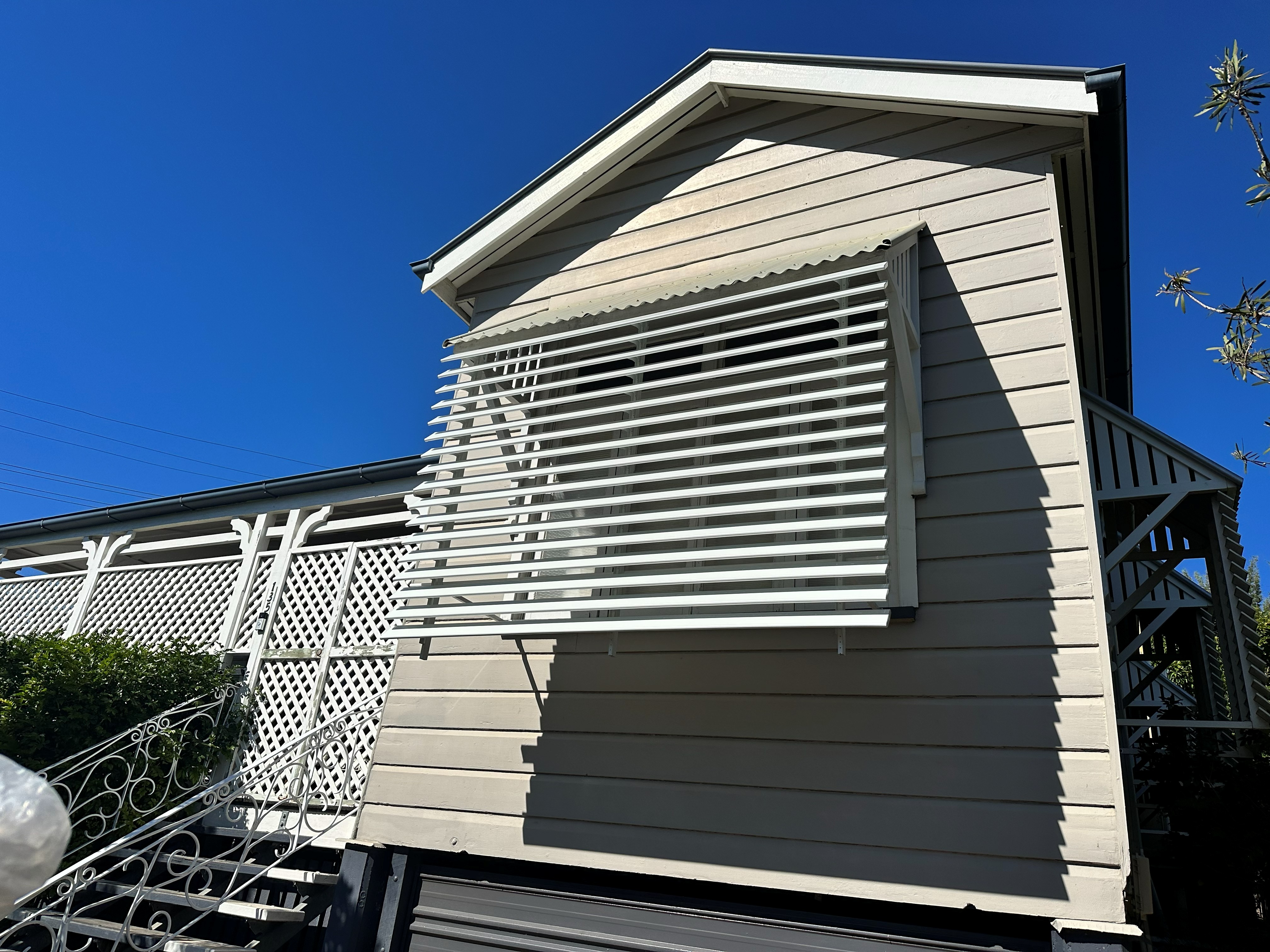 White louvre awning fitted over a Queenslander-style home window