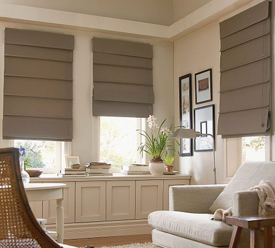 Taupe roman blinds fitted to three living room windows