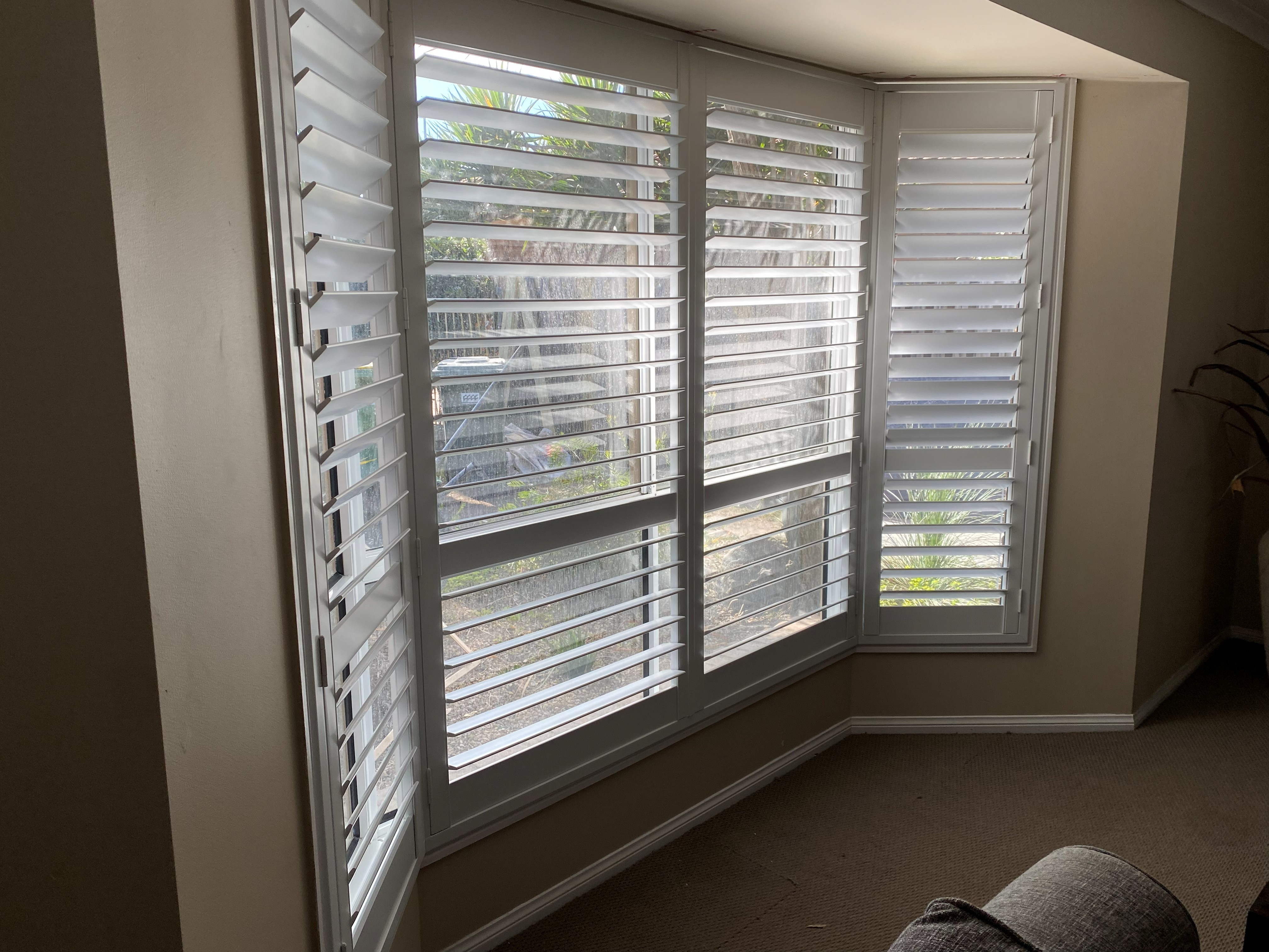 Plantation shutters in a two-storey entry with a high vaulted ceiling