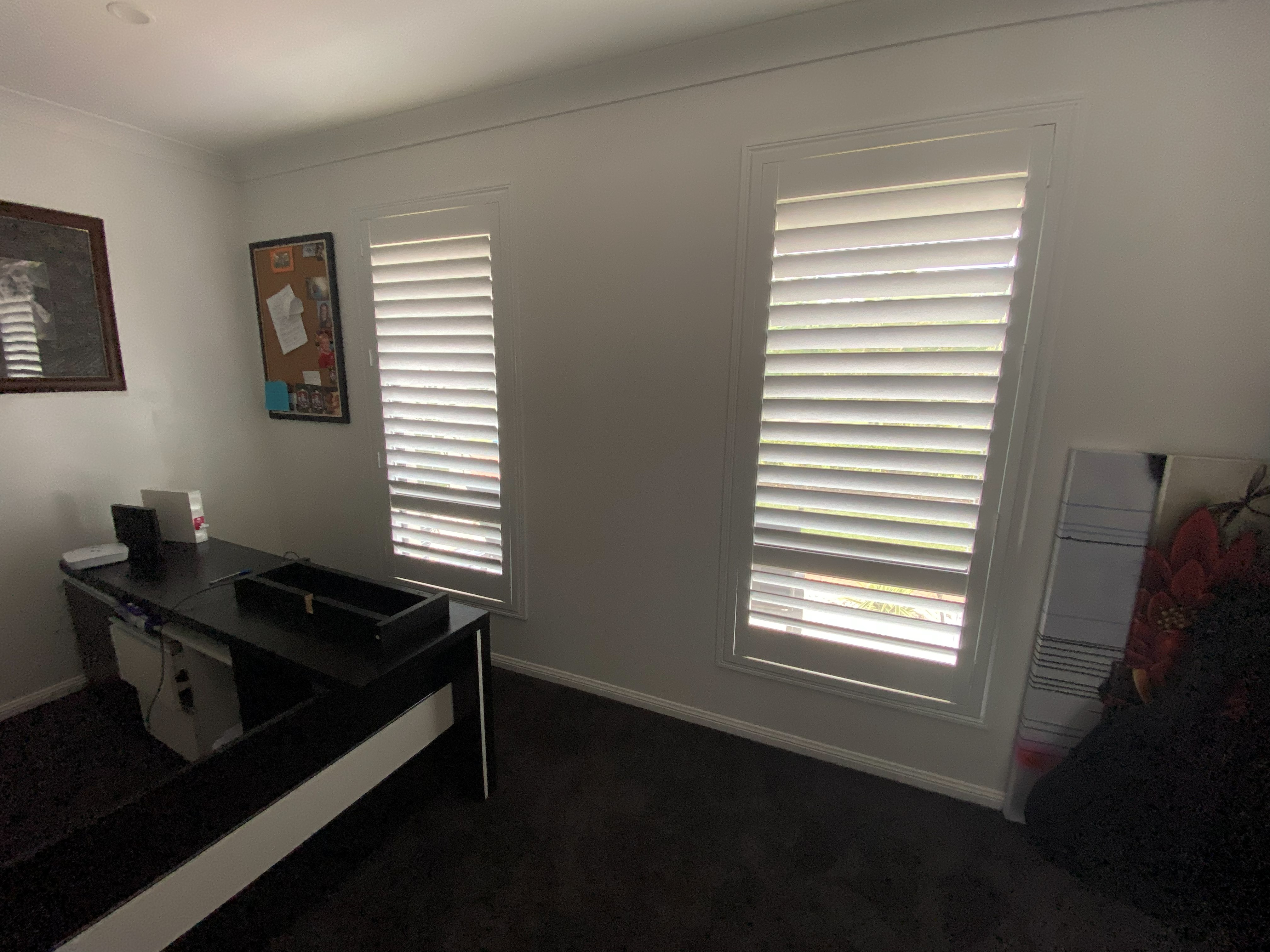 Plantation shutters over sliding doors in a living and dining room