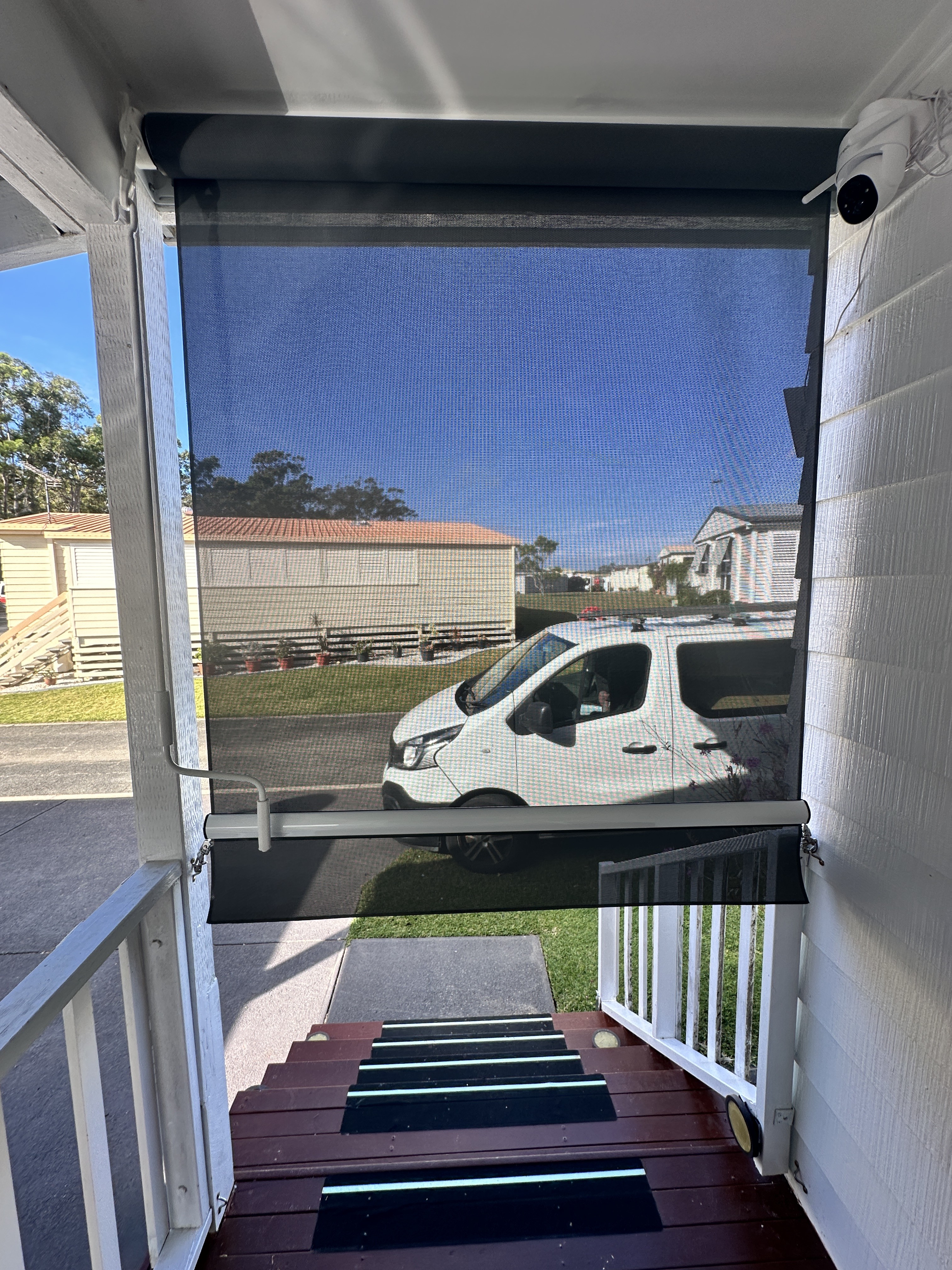 Straight drop awning lowered over a front entry stairway
