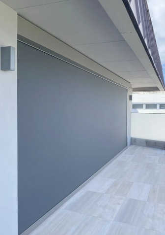 Dark grey Zipscreen Extreme fully lowered on an elevated balcony