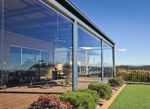Zipscreen PVC panels enclosing a deck with hill and garden views