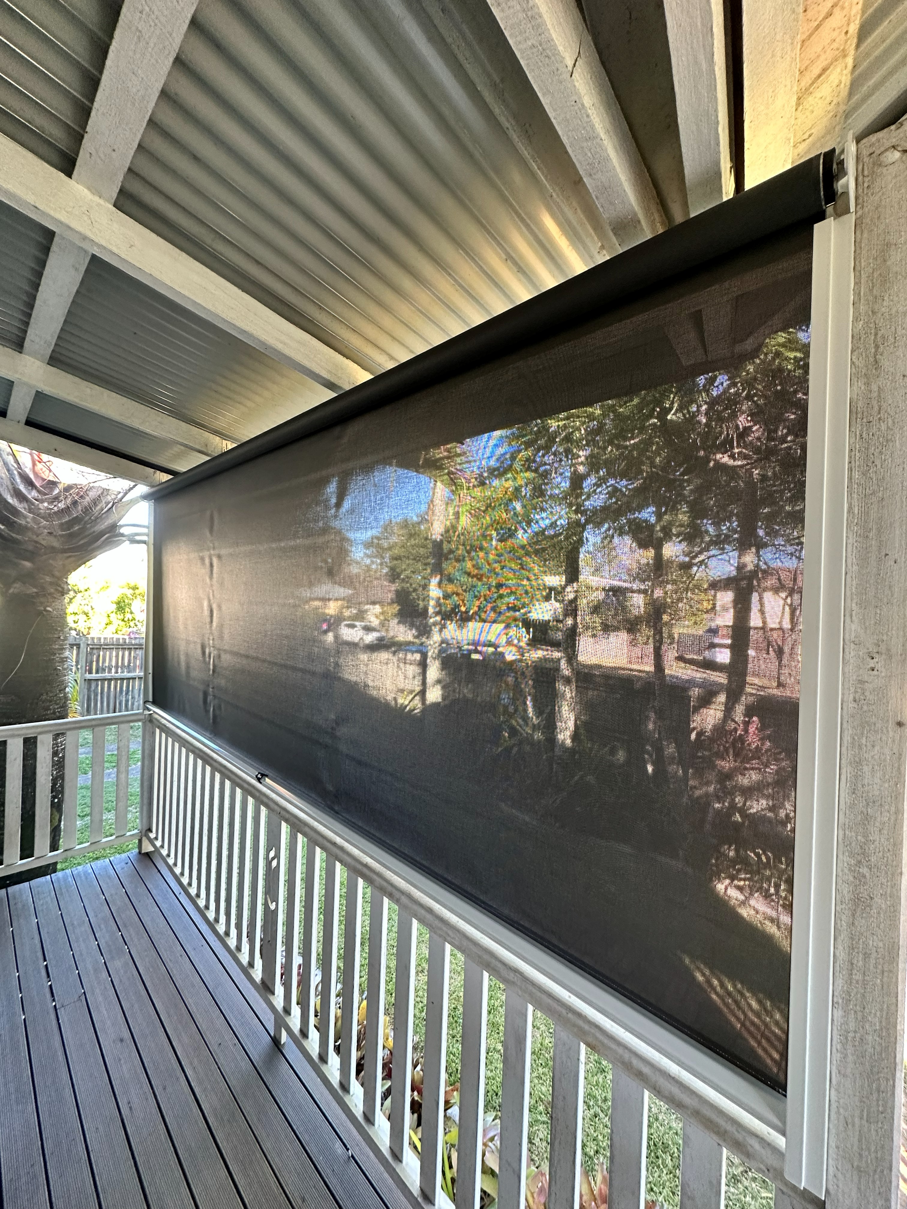 Zipscreen outdoor blind lowered on a covered deck
